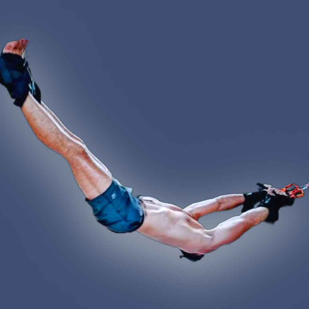 Pravilo therapy session showing a man suspended horizontally in a deep backbend, held by wrist and ankle cuffs.